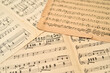 © zdravinjo - Old sheets with music notes scattered on the table. Close-up. Retro style. Selective focus.