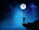 Fototapeta Na sufit - Kid boy catching moon . Mixed media