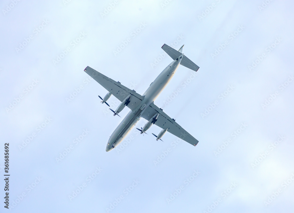 Turboprop aircraft flying through the sky at low altitude Stock Photo ...