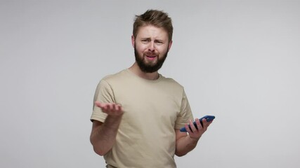 Wall Mural - omg, what is this? bearded man looking at camera with disappointment, gesturing indignant expression