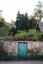Blue Garden Door In Stone Wall In French Village