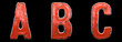 Set of letters A, B, C made of red painted metal isolated on black background. 3d