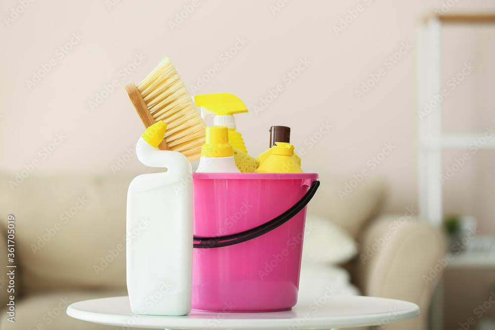 Set of cleaning supplies on table in room