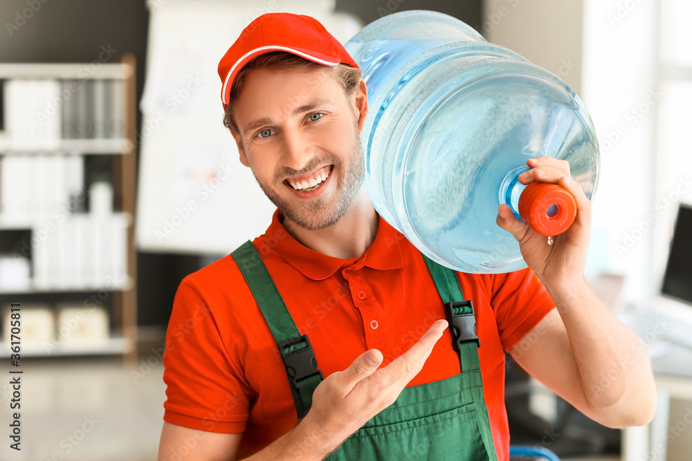 Delivery man with bottle of water in office