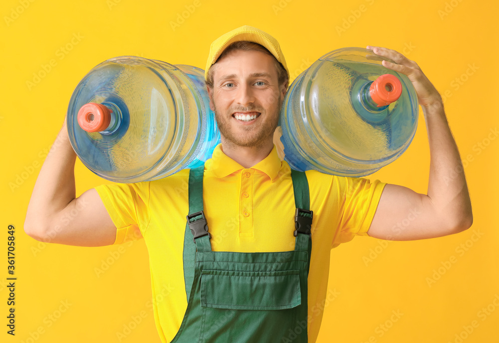 Delivery man with bottles of water on color background