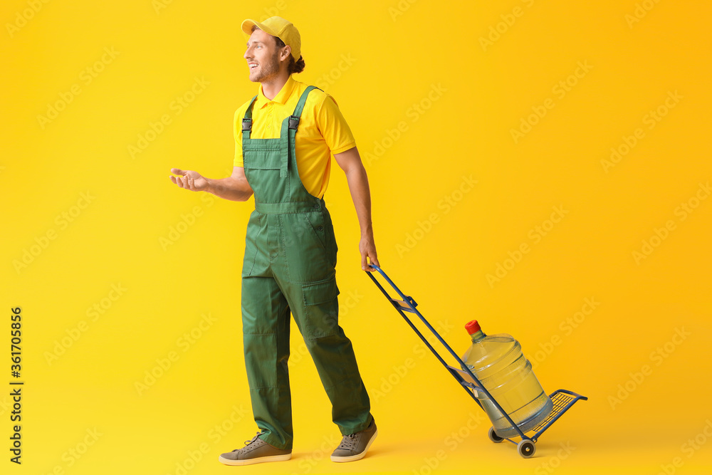 Delivery man with bottle of water on color background