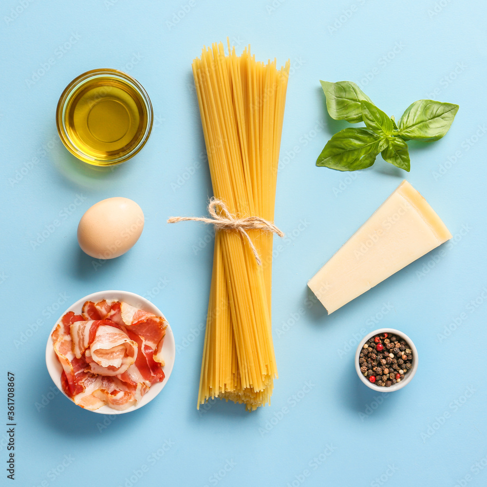 Ingredients for tasty pasta carbonara on color background