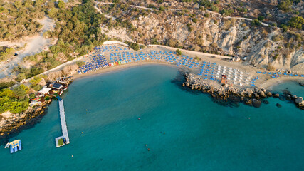 Wall Mural - Aerial bird's eye view of Konnos beach in Cavo Greco Protaras, Paralimni, Famagusta, Cyprus. The famous tourist attraction golden sandy Konos bay, yachts, on summer holidays, at sunrise from above