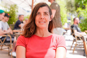 smiling vacation woman sit on cafe restaurant table outdoor in summer day