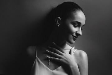  Beauty fashion portrait of a beautiful young woman with make-up, manicure, and jewelry. Black and white photo