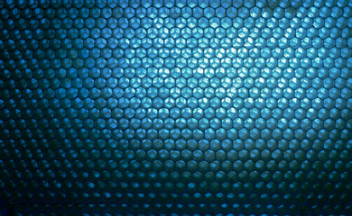 Close-up view of abstract futuristic looking blue honeycomb background with copy space