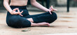© May Chanikran - Young woman sitting for lotus meditation pose, close up on hands.