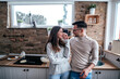 © bnenin - Cute couple in the kitchen, standing and looking at each other.