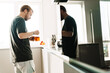 © Drobot Dean - Photo of caucasian redhead man drinking tea while standing in kitchen
