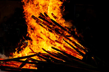 Bonfire that burns on a dark background, wood burning flame.