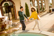 © BGStock72 - Young multiethnic couple walking by the fountain
