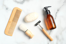 Flat Lay Composition With Bath Accessories And Shaving Tools For Man On Marble Background. Top View Wooden Hair Comb, Handmade Soap, Shaving Brush, Razor, Shampoo Bottle.
