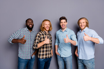 Wall Mural - Portrait of four nice attractive glad confident cheerful cheery guys showing thumbup advice ad advert agree deal done isolated over gray purple pastel color background