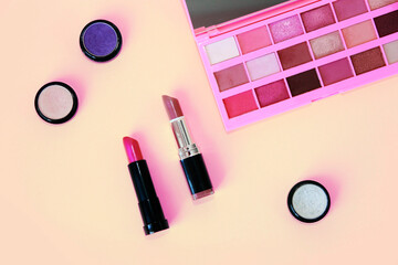 decorative cosmetics, lipstick and a palette with multi-colored shadows