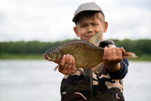 Seven Year Old Boy Holds A Fish He Caught