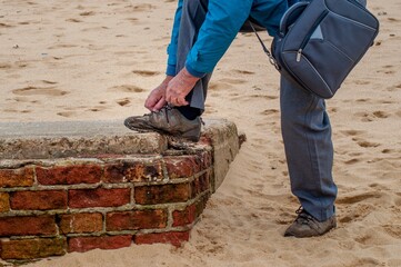 Canvas Print - Close up shot of a male tying his shoes