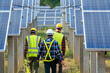 © visoot - Electrician with engineer wearing a medicine healthcare mask working and checking at solar power station,Solar energy panels,Renewable energy friendly management systems concept.