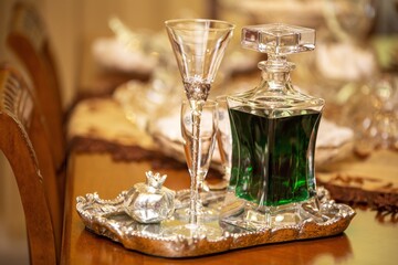 Sticker - Selective focus shot of a decorative bottle of drink and glasses on a silver tray