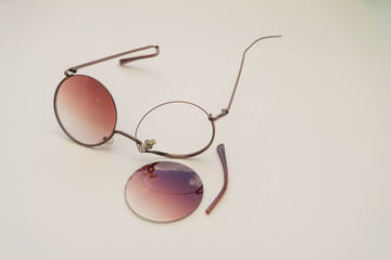 Broken sunglasses with round lenses