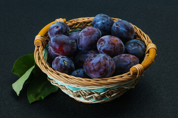 Ripe plum heap in the basket