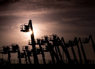 Canvas Print - Silhouette shot of cranes in the seaport