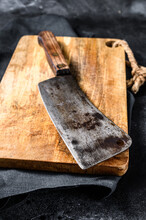 Vintage Butcher Meat Cleaver On Concrete Board. Black Background. Top View