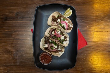 Sticker - Top view of delicious tacos with salsa on a tray on the table