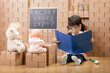 © M-image - toddler girl pretend play as a teacher at home