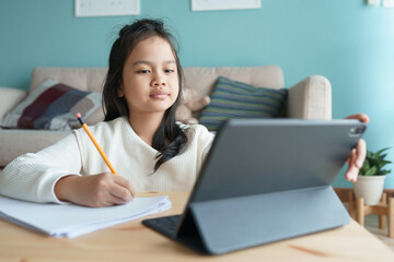 Education. Asian girl is learning with online tutor on tablet digital 