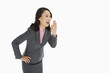© ImageHit - Businesswoman showing a whispering gesture