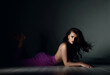 © Dmitry Lobanov - Young sensual brunette woman in purple trousers and naked upper body breast is lying on floor in sexy pose looking at camera