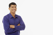 © ImageHit - Man standing with arms crossed, smiling