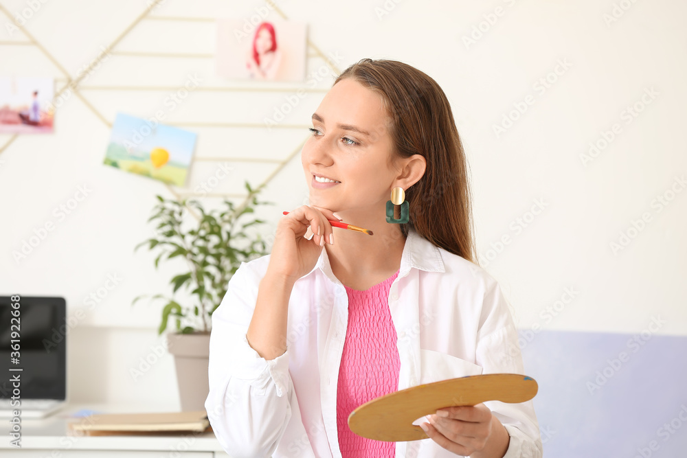 Beautiful female painter at home