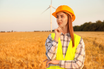 Wall Mural - Female engineer on windmill farm for electric power production