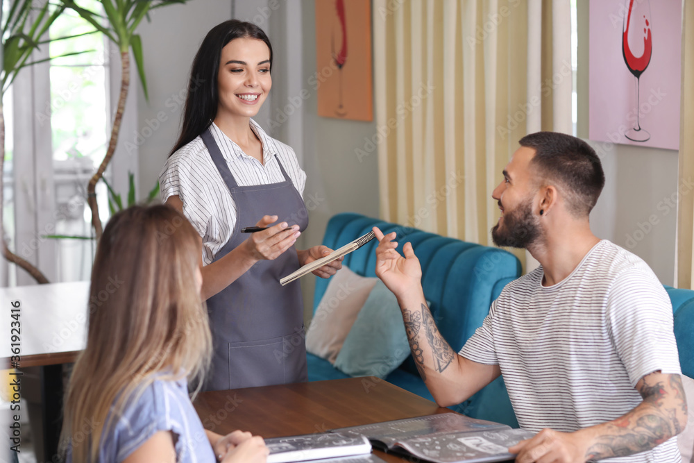 Waitress serving clients in restaurant