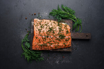 Cooking traditional Scandinavian salted salmon gravlax. Fish fillet with dill, salt and spices