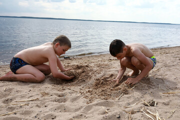 Children play on sandy beach of Lake Seliger