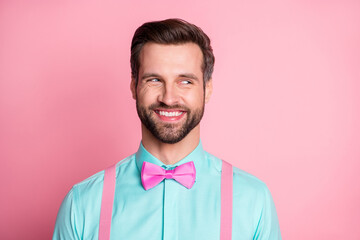 Poster - Photo of handsome guy trend clothes look side empty space know evil secret toothy smile cunning chatterbox person wear shirt suspenders bow tie isolated pastel pink color background