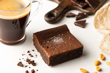 Wall Mural -  selective focus of delicious brownie piece near coffee on white background