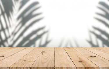 Wall Mural - Empty top wooden table with blurred tree shadow on concrete wall background