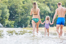 Family With Daughter Runs Wildly In The Sea