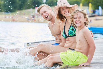 Wall Mural - Family with son while splashing in the water