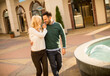 © BGStock72 - Beautiful smiling love couple walking by the fountain on a sunny day