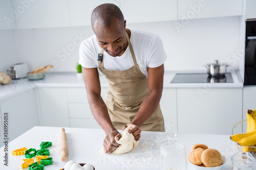 Portrait of nice attractive guy making fresh bread pie pide doughing flour learning practicing courses lesson classes workshop spending free time in modern light white interior house kitchen