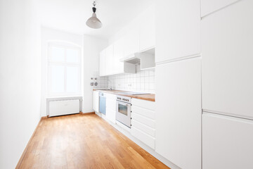 modern white kitchen or kitchenette in empty flat